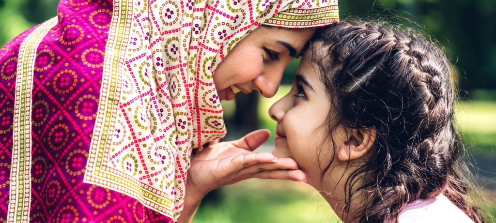 muslim mother and daughter looking each other in the eyes