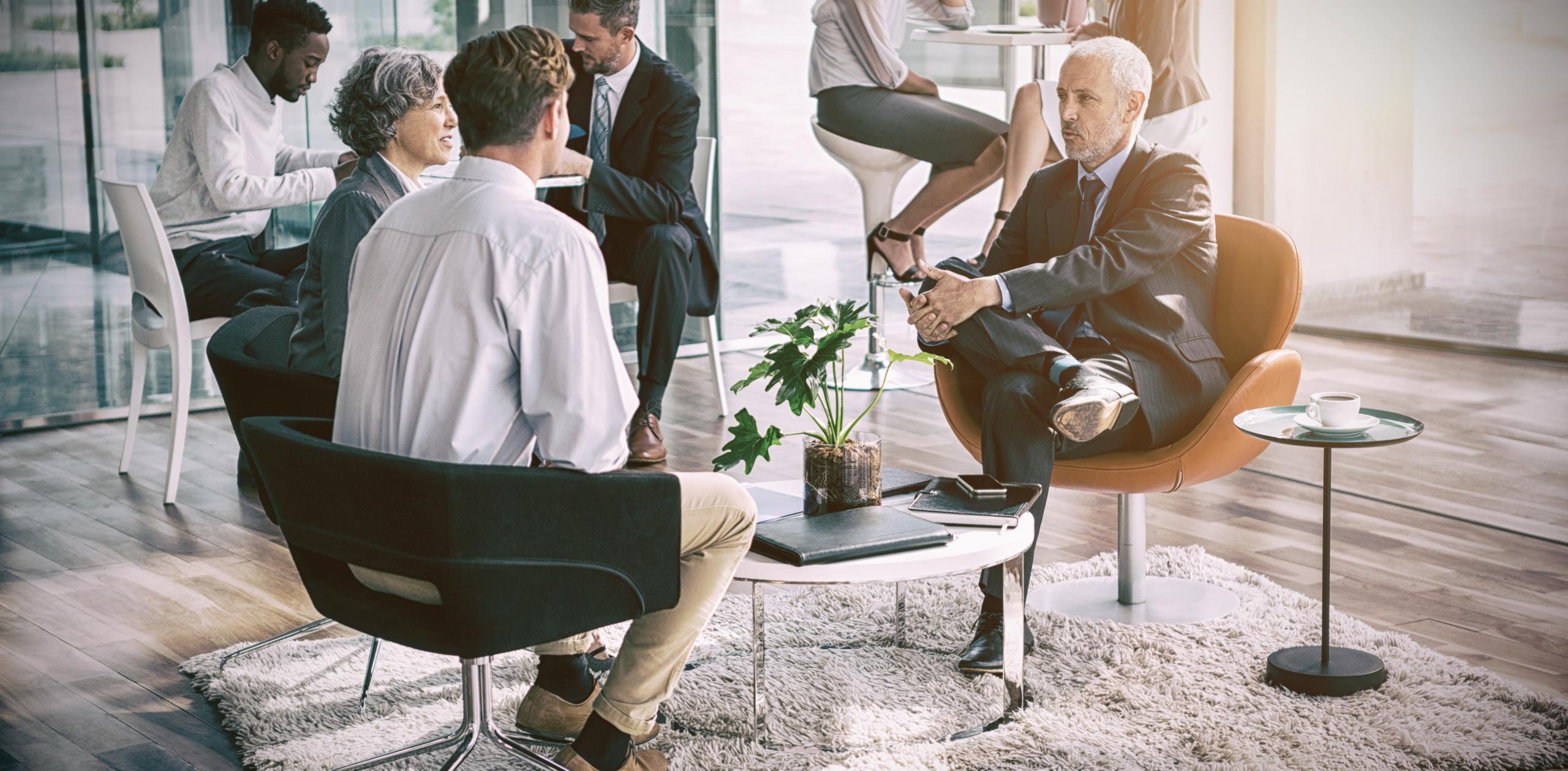 group of business professionals having a meeting in fancy conference room