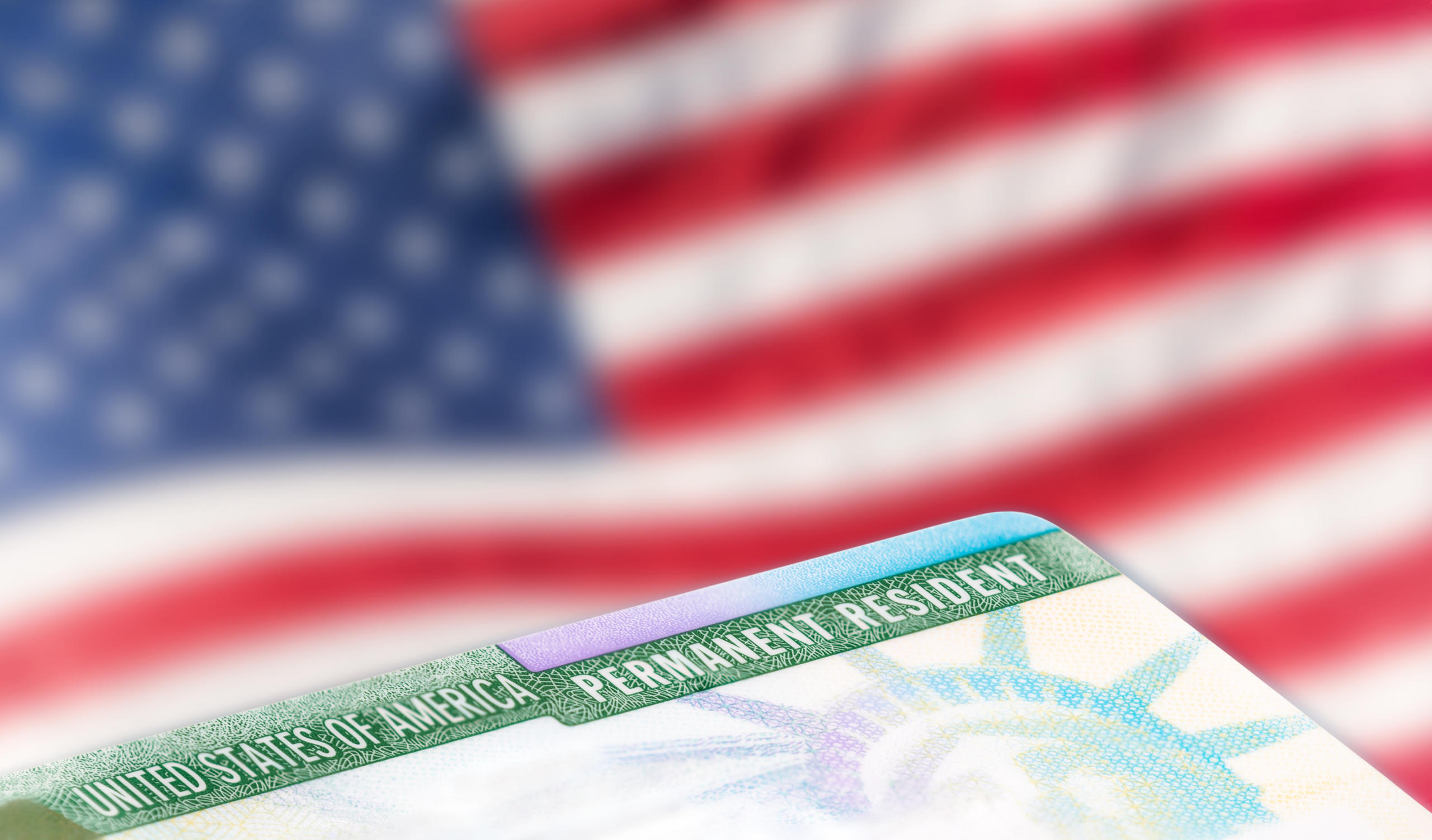 American permanent resident card with american flag in background