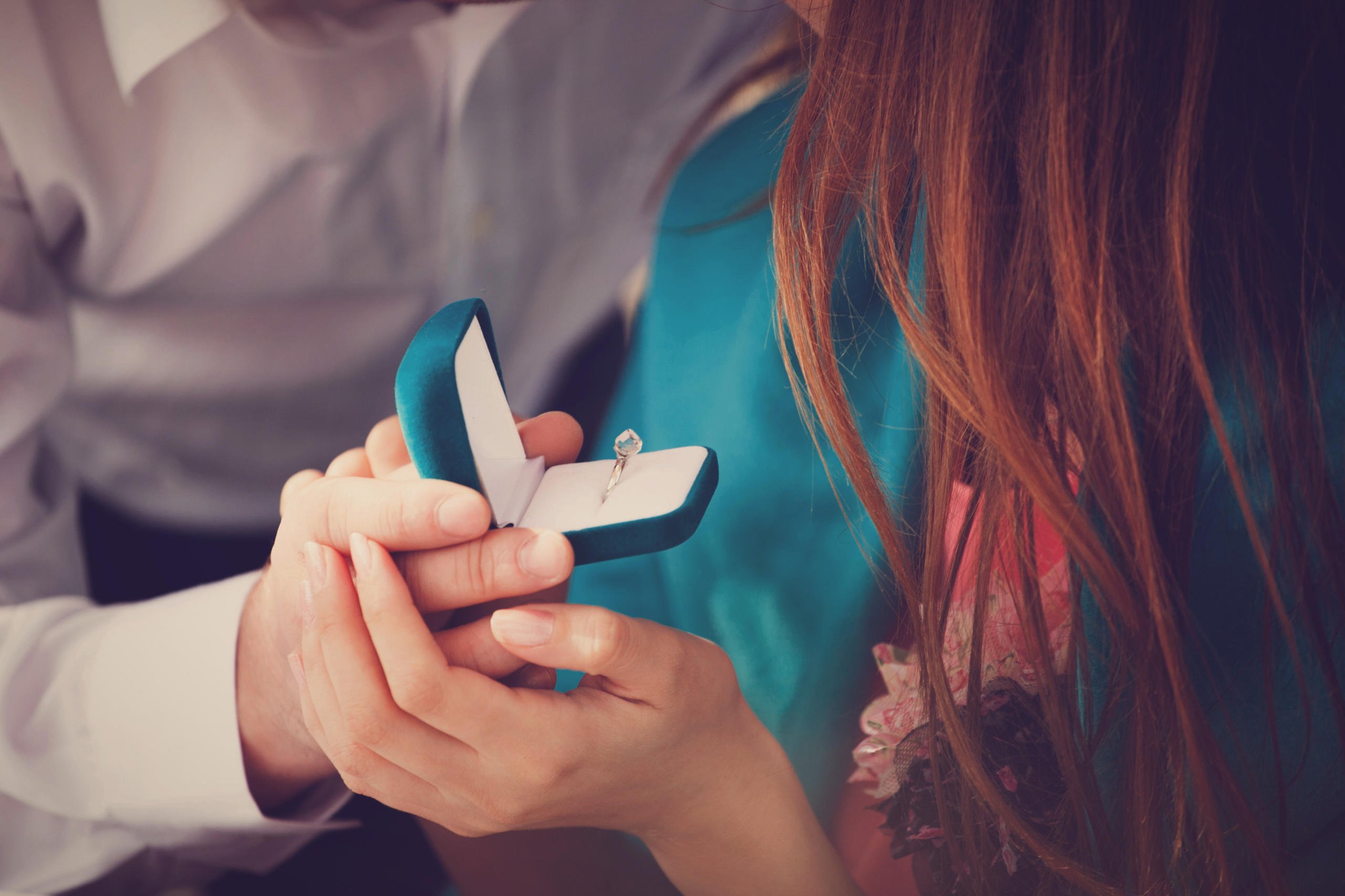 A young man makes a marriage proposal to his girlfriend and surprises her with a beautiful engagement ring