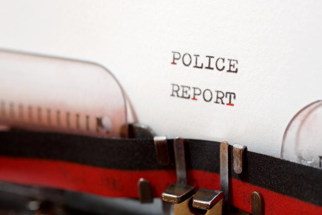 closeup of typewriter with police report typed on paper