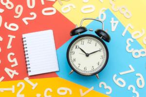 decorative image of a clock and feature image for How Long Can You Live Outside the US Without Losing Your Green Card