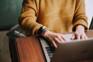 woman typing on computer feature image for what is a uscis online account number