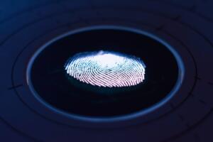 image of a finger print on a dark piece of glass