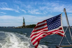 american flag on back of boat and feature image for B1 and B2 Visa Interview Questions