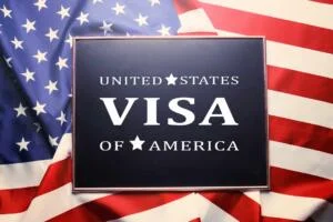 An American flag with the text Visa, representing the topic of working in the USA on a B1/B2 visitor visa