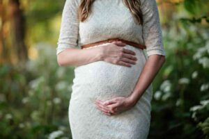 pregnant woman holding belly